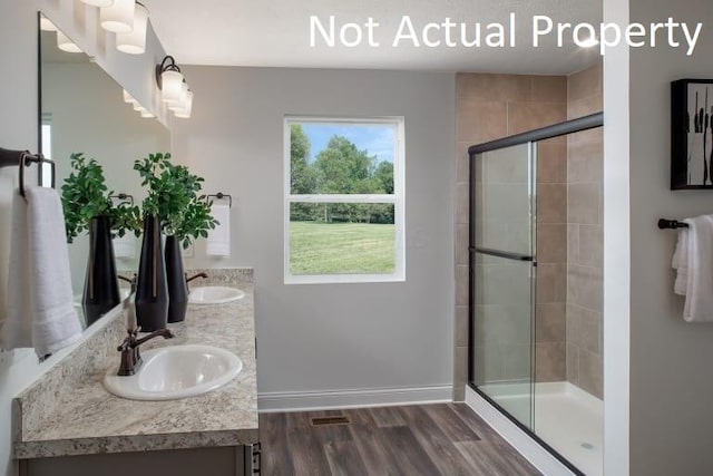 3323 Tender Ave Lot 7165, Powell, OH 43065 - bathroom featuring double vanity, a shower stall, and wood finished floors