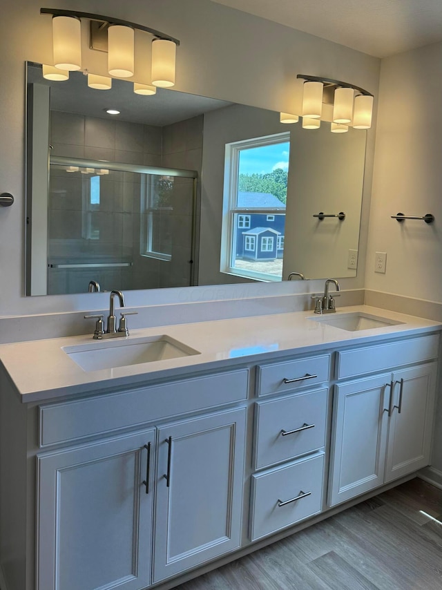 3323 Tender Ave Lot 7165, Powell, OH 43065 - bathroom with double vanity, tiled shower, and wood finished floors