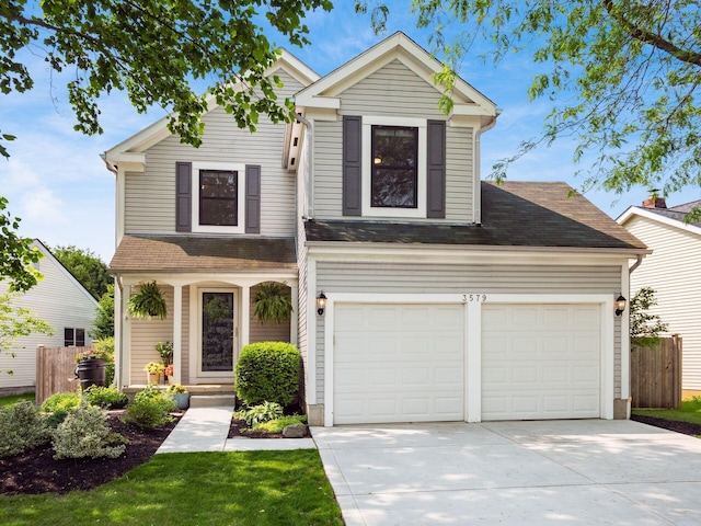3579 Aaron Dr, Columbus, OH 43228 - traditional home with concrete driveway, a shingled roof, and a garage
