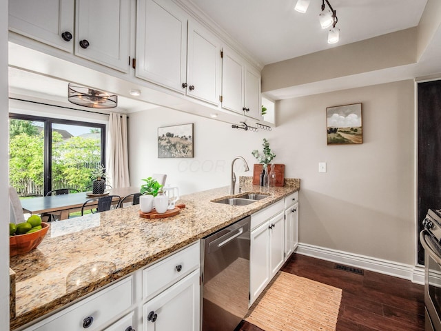 3579 Aaron Dr, Columbus, OH 43228 - kitchen featuring stainless steel dishwasher, a sink, baseboards, dark wood-style floors, and a peninsula
