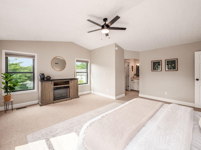 3579 Aaron Dr, Columbus, OH 43228 - bedroom with light colored carpet, vaulted ceiling, baseboards, a fireplace, and ensuite bath