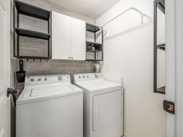 3579 Aaron Dr, Columbus, OH 43228 - laundry area with cabinet space and washing machine and clothes dryer