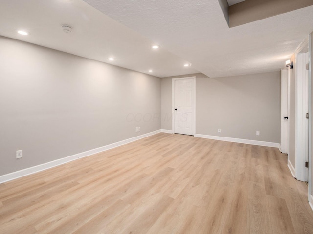 3579 Aaron Dr, Columbus, OH 43228 - finished below grade area featuring light wood-style floors, baseboards, recessed lighting, and a textured ceiling