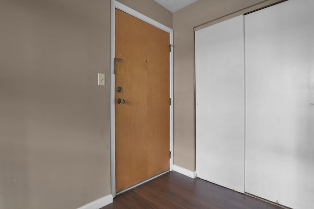 1530 Slade Ave Unit 103, Columbus, OH 43235 - unfurnished bedroom with dark wood-style flooring, baseboards, and a closet