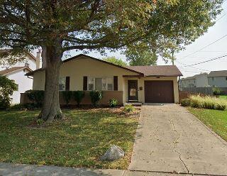 5102 Avalon Ave, Columbus, OH 43229 - ranch-style house featuring a garage, driveway, stucco siding, and a front yard
