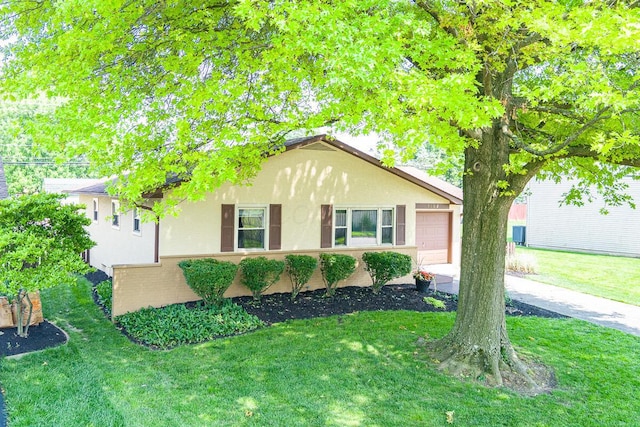 5102 Avalon Ave, Columbus, OH 43229 - view of front facade with stucco siding, a front yard, and a garage