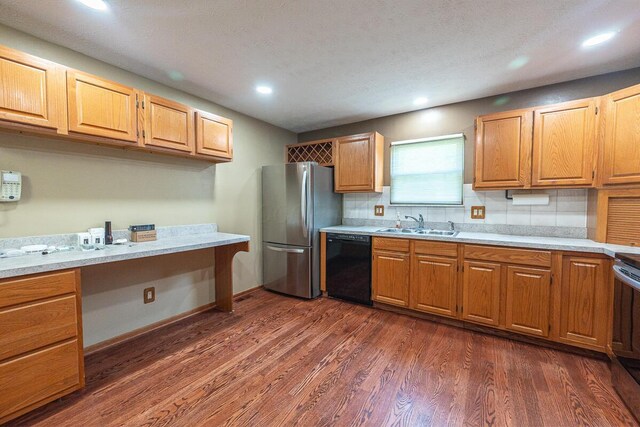 5102 Avalon Ave, Columbus, OH 43229 - kitchen with black dishwasher, freestanding refrigerator, light countertops, dark wood-style flooring, and recessed lighting
