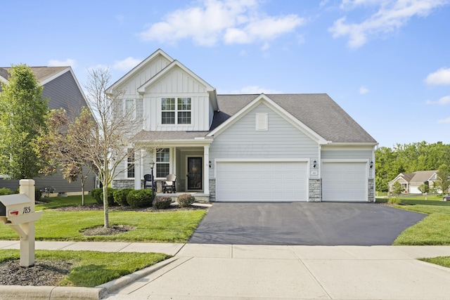 185 Saffron Dr, Sunbury, OH 43074 - view of front of property featuring board and batten siding, asphalt driveway, and a front yard