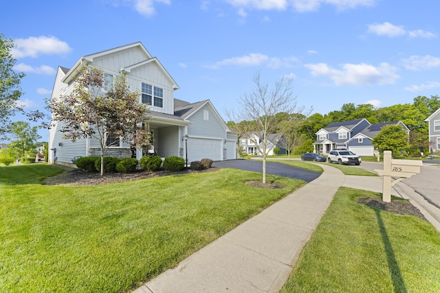 185 Saffron Dr, Sunbury, OH 43074 - view of front of house with a residential view, driveway, board and batten siding, and a front lawn