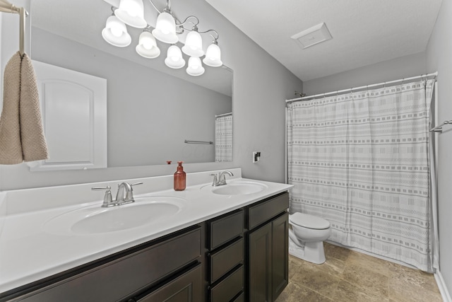 185 Saffron Dr, Sunbury, OH 43074 - bathroom with double vanity, toilet, a chandelier, curtained shower, and stone finish floors