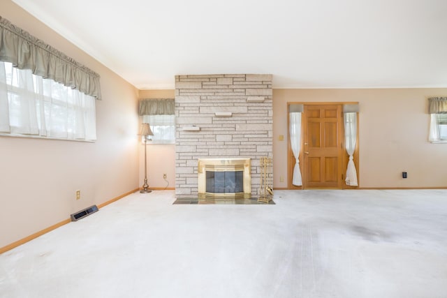 803 Wiltshire Rd, Columbus, OH 43204 - unfurnished living room with carpet floors, a stone fireplace, and baseboards