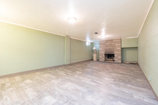 803 Wiltshire Rd, Columbus, OH 43204 - unfurnished living room featuring a fireplace, wood finished floors, concrete block wall, and crown molding