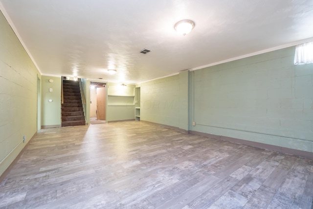 803 Wiltshire Rd, Columbus, OH 43204 - spare room with stairs, wood finished floors, concrete block wall, and ornamental molding