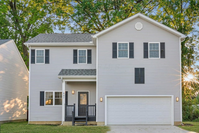 887 Harbinger Cir W, Columbus, OH 43213 - traditional-style home with an attached garage, driveway, and a shingled roof