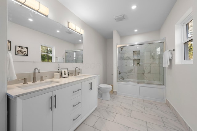 887 Harbinger Cir W, Columbus, OH 43213 - full bathroom with marble look tiles, toilet, healthy amount of natural light, combined bath / shower with glass door, and recessed lighting