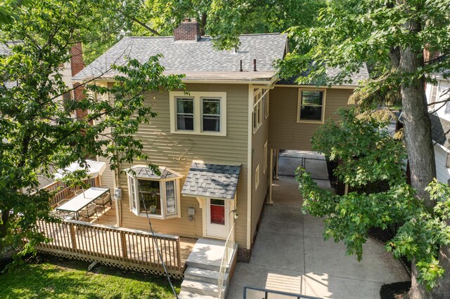 203 Winthrop Rd, Columbus, OH 43214 - back of property featuring a chimney, a shingled roof, and a wooden deck