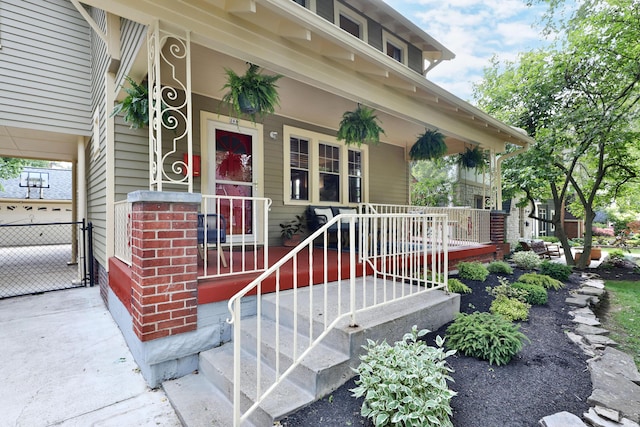 203 Winthrop Rd, Columbus, OH 43214 - entrance to property featuring covered porch, brick siding, and a gate