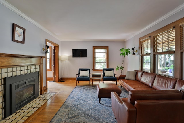 203 Winthrop Rd, Columbus, OH 43214 - living room with light wood finished floors, crown molding, a tiled fireplace, and baseboards
