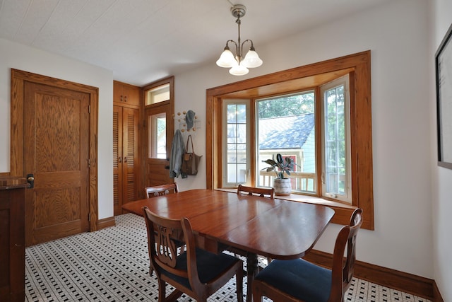 203 Winthrop Rd, Columbus, OH 43214 - dining area featuring baseboards and a chandelier