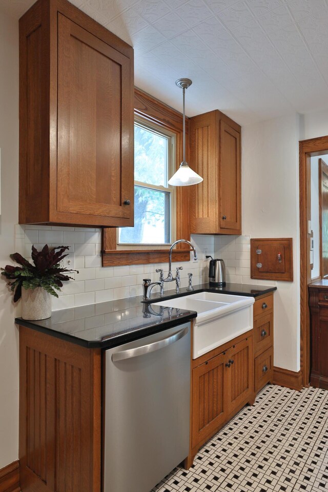 203 Winthrop Rd, Columbus, OH 43214 - kitchen with dishwasher, brown cabinets, backsplash, dark countertops, and pendant lighting