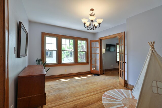 203 Winthrop Rd, Columbus, OH 43214 - interior space featuring a chandelier, baseboards, light wood finished floors, and french doors