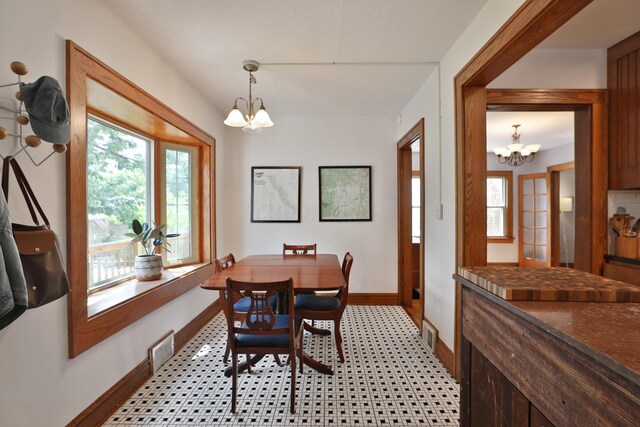 203 Winthrop Rd, Columbus, OH 43214 - dining room featuring a chandelier, baseboards, and light flooring