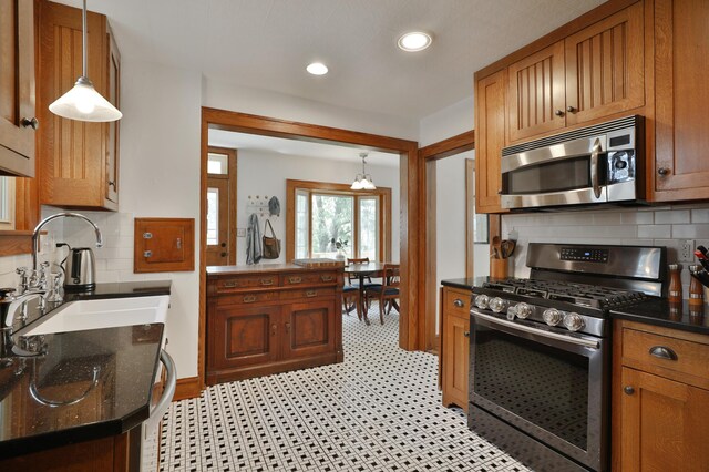 203 Winthrop Rd, Columbus, OH 43214 - kitchen featuring appliances with stainless steel finishes, a sink, tasteful backsplash, recessed lighting, and brown cabinets