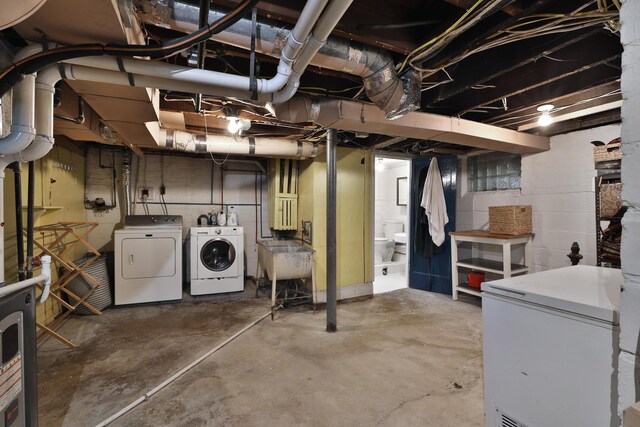 203 Winthrop Rd, Columbus, OH 43214 - unfinished basement with washer and clothes dryer, white fridge, and a sink