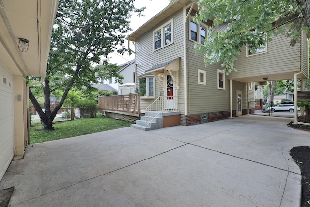 203 Winthrop Rd, Columbus, OH 43214 - back of house featuring driveway, crawl space, and a carport