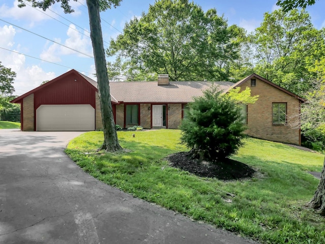 8587 Blacks Rd, Pataskala, OH 43062 - view of front of house with a chimney, a front yard, asphalt driveway, a garage, and brick siding