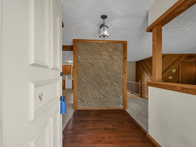 8587 Blacks Rd, Pataskala, OH 43062 - corridor with hardwood / wood-style flooring, wood walls, a textured ceiling, and an upstairs landing