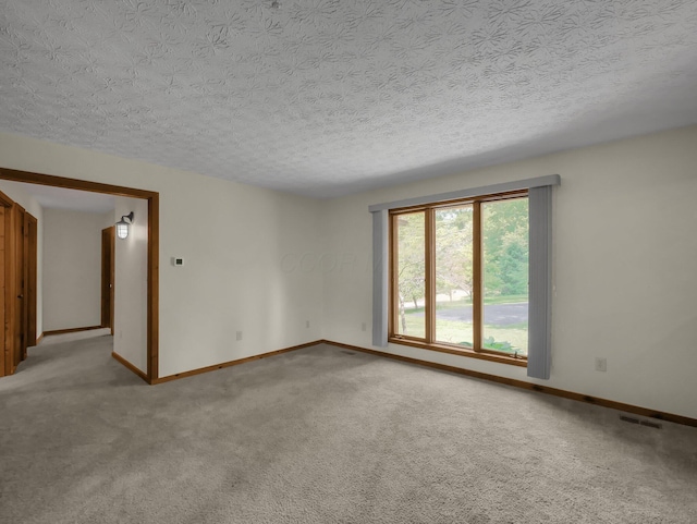 8587 Blacks Rd, Pataskala, OH 43062 - spare room featuring a textured ceiling, light carpet, and baseboards