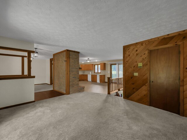 8587 Blacks Rd, Pataskala, OH 43062 - unfurnished living room with baseboards, carpet flooring, and a textured ceiling