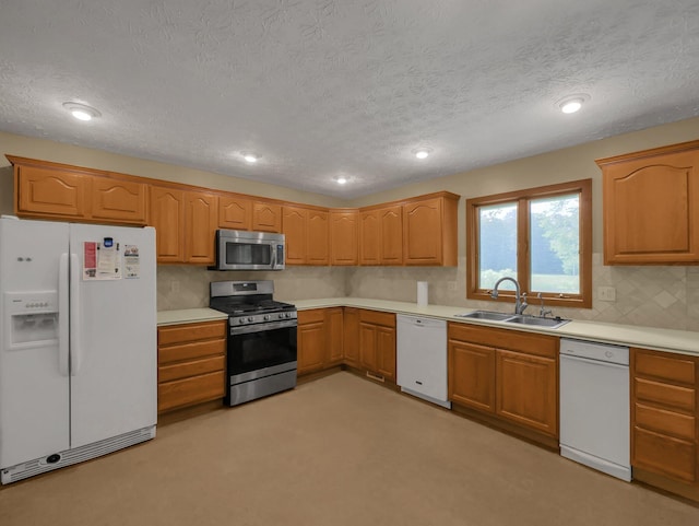 8587 Blacks Rd, Pataskala, OH 43062 - kitchen with stainless steel appliances, a sink, a textured ceiling, backsplash, and light countertops