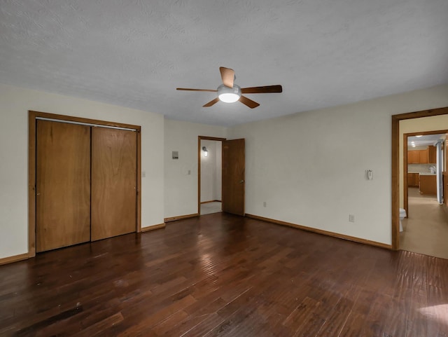 8587 Blacks Rd, Pataskala, OH 43062 - unfurnished bedroom with dark wood-type flooring, baseboards, a closet, and a ceiling fan