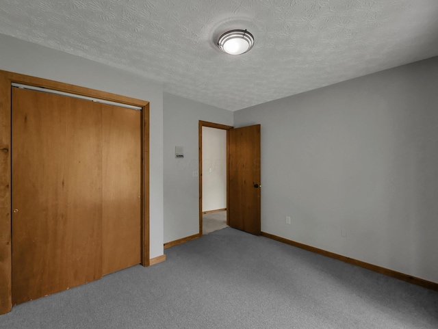 8587 Blacks Rd, Pataskala, OH 43062 - unfurnished bedroom featuring baseboards, a closet, carpet floors, and a textured ceiling