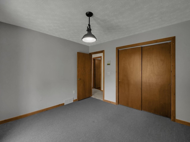 8587 Blacks Rd, Pataskala, OH 43062 - unfurnished bedroom featuring baseboards, a closet, carpet floors, and a textured ceiling