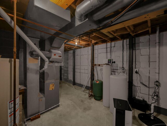 8587 Blacks Rd, Pataskala, OH 43062 - unfinished basement featuring gas water heater, a water softener system, a water pressure tank, and heating unit