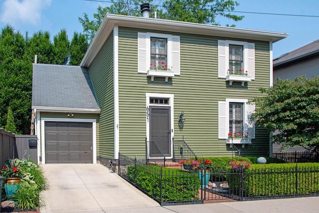 651 S 6th St, Columbus, OH 43206 - view of front facade featuring driveway, a fenced front yard, and a garage