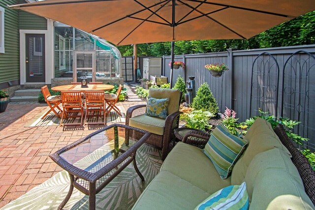 651 S 6th St, Columbus, OH 43206 - fenced backyard featuring a patio, outdoor dining area, an outdoor hangout area, and entry steps