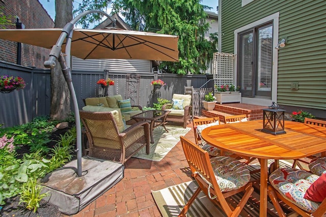 651 S 6th St, Columbus, OH 43206 - fenced backyard featuring a patio, outdoor dining space, and an outdoor hangout area