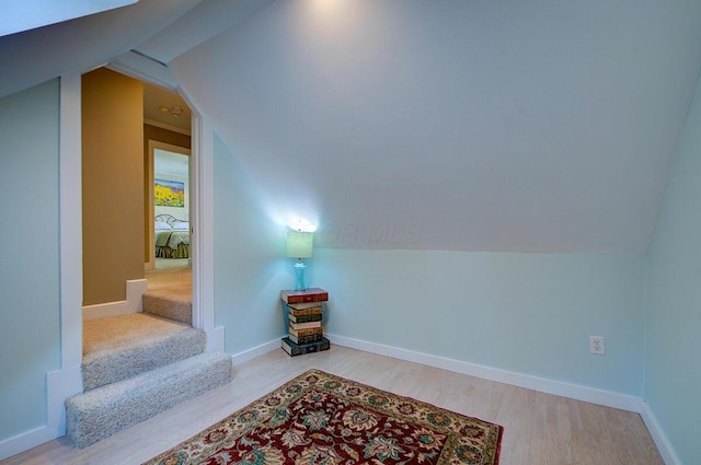 651 S 6th St, Columbus, OH 43206 - additional living space with wood finished floors, lofted ceiling, baseboards, and stairway