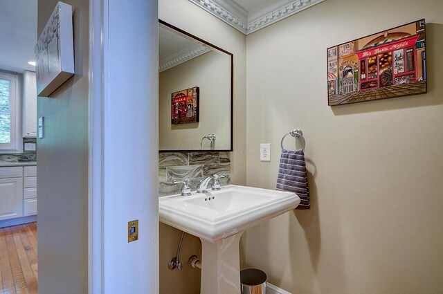 651 S 6th St, Columbus, OH 43206 - bathroom featuring decorative backsplash, crown molding, and wood finished floors