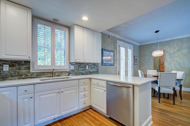 651 S 6th St, Columbus, OH 43206 - kitchen featuring stainless steel dishwasher, a sink, plenty of natural light, a peninsula, and ornamental molding