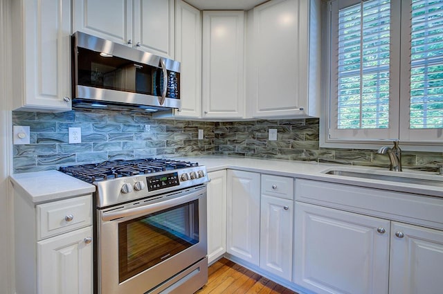 651 S 6th St, Columbus, OH 43206 - kitchen with appliances with stainless steel finishes, a sink, healthy amount of natural light, and light countertops