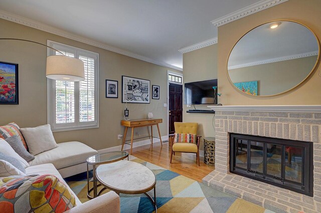 651 S 6th St, Columbus, OH 43206 - living area featuring a brick fireplace, wood finished floors, ornamental molding, and baseboards
