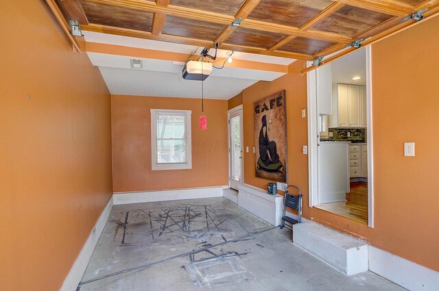 651 S 6th St, Columbus, OH 43206 - garage featuring baseboards and a garage door opener