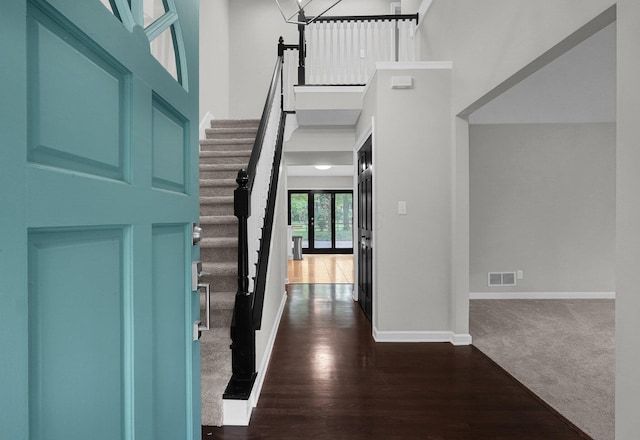 6233 Coonpath Rd NW, Carroll, OH 43112 - foyer entrance featuring a towering ceiling, dark wood finished floors, dark carpet, and stairway