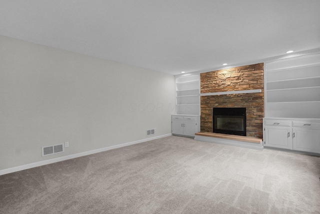 6233 Coonpath Rd NW, Carroll, OH 43112 - unfurnished living room featuring light colored carpet, a stone fireplace, built in features, and recessed lighting