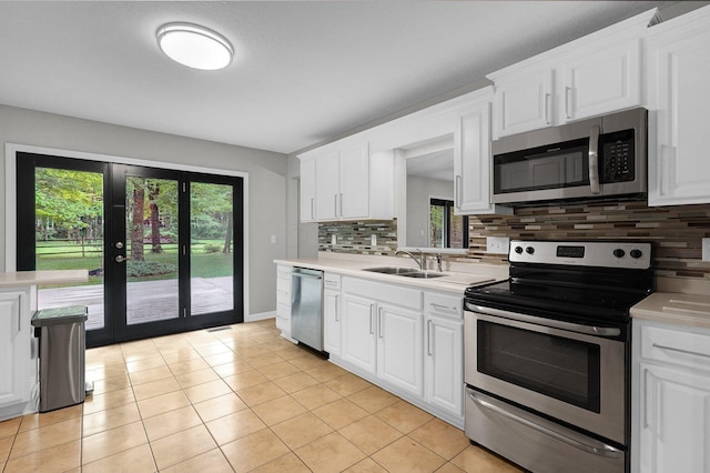 6233 Coonpath Rd NW, Carroll, OH 43112 - kitchen featuring appliances with stainless steel finishes, light countertops, healthy amount of natural light, and backsplash